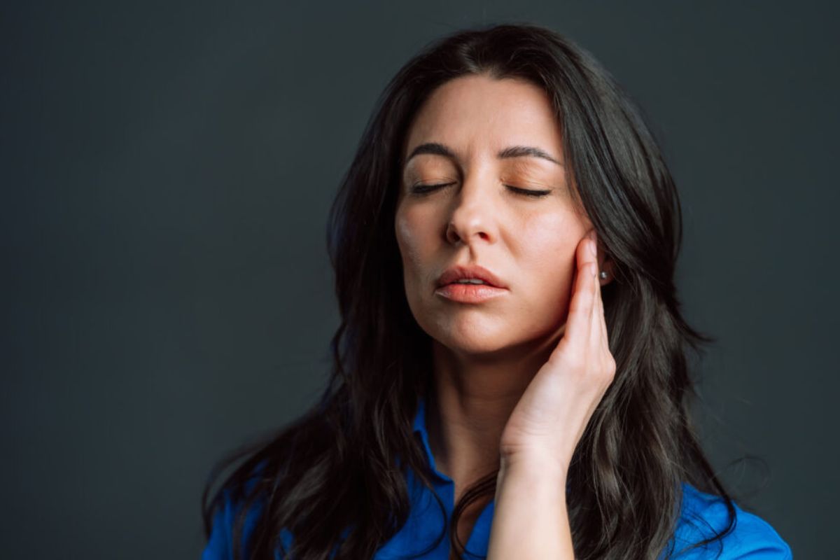 bored mature woman with long hair having headache